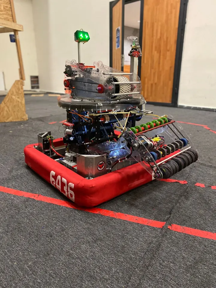 Pars Robotics' 2022 FRC robot, red bumpers numbered 6436, on the practice field.